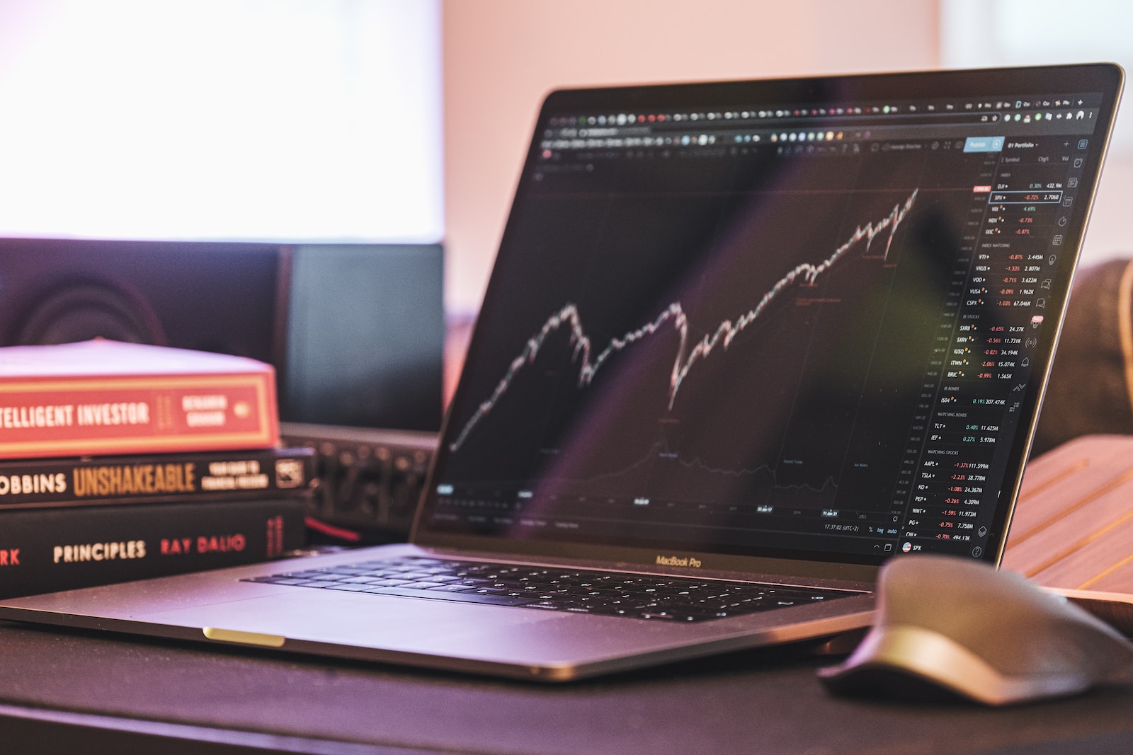 laptop computer showing rising stock market